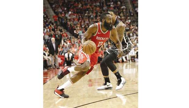 James Harden (left) of Houston Rockets drives past Rudy Gay of San Antonio Spurs during the NBA game in Houston, Texas, on Monday. (AFP)