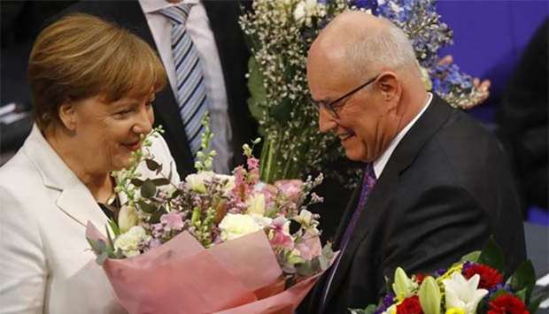 German Chancellor Angela Merkel is congratulated after being re-elected in Berlin on Wednesday.