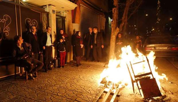Iranian families light fire outside their houses in Tehran on March 13, 2018 during the Wednesday Fire feast, or Chaharshanbeh Soori, held annually on the last Wednesday eve before the Spring holiday of Noruz.