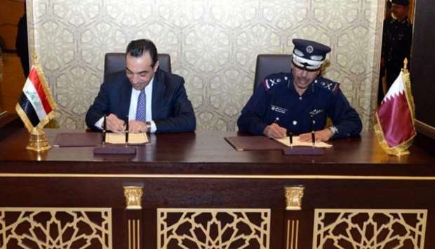 Director General of Public Security Saad bin Jassim al-Khulaifi and Undersecretary of the Iraqi Minister of Interior for Federal Intelligence and Investigations Maher Najm Abdul Hussein signing the MoU.