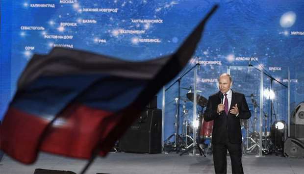Russian President Vladimir Putin addresses supporters during a rally