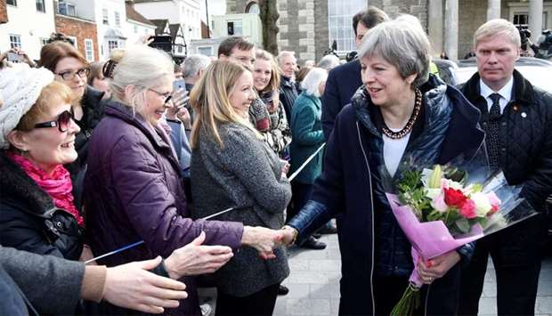 Britain's Prime Minister Theresa May (2R) meets members of the public during her visit to Salisbury, southern England