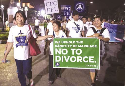 This photo taken on February 24, 2018 shows Philippine Catholic faithful holding a banner as they take part in a u201cWalk for Lifeu201d protest at a park in Manila.