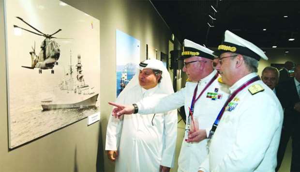 Katara's Ahmed al-Sayyed, Italian Navy chief Rear Admiral Valter Girardelli and another official viewing pictures at the exhibition.