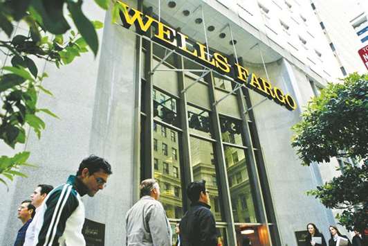 Pedestrians walk past Wells Fargou2019s corporate headquarters in San Francisco. In July, Wells Fargo blamed a third-party vendor for wrongly layering insurance policies on its auto borrowers. Wells Fargo did not explain that it received payouts when those policies were written.