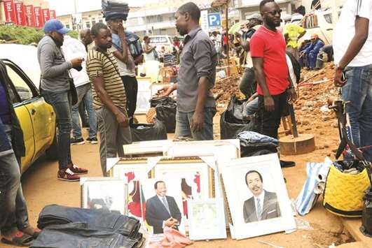 Pictures of President Biya are displayed for sale in a market in Yaounde.