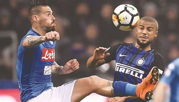 Napoliu2019s Slovakian midfielder Marek Hamsik (left) and Inter Milanu2019s Brazilian forward Rafinha vying for the ball during their Serie A match at the San Siro stadium in Milan on March 11. (AFP)