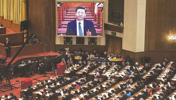 Chinau2019s President Xi Jinping is seen on a large screen over delegates as he joins a session of the National Peopleu2019s Congress to vote on a constitutional amendment on March 11. Chinese lawmakers abolished presidential term limits and paved the way for Xi Jinping to rule indefinitely.