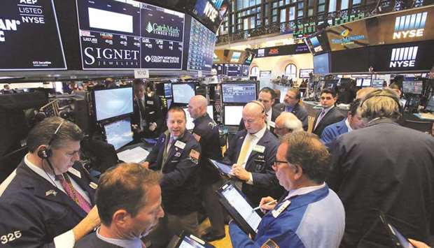 Traders work on the trading floor at the New York Stock Exchange in Manhattan. Outsized returns delivered by Amazon.com, Netflix and other heavyweight technology stocks have made them heroes on Wall Street, but some strategists warn that investorsu2019 reliance on them exacerbates the risk of a steep downturn.