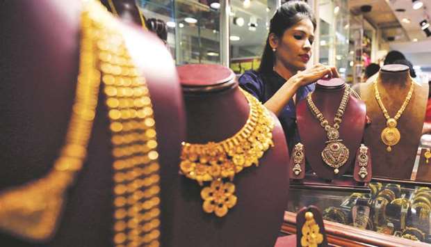 A salesperson is seen inside a jewellery showroom in Mumbai. Gold dealers in India were offering a discount of up to $3 an ounce over official domestic prices to lure customers.