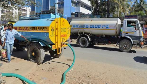 Tankers delivering water to apartments in Bangalore
