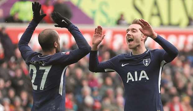 Tottenham Hotspuru2019s Danish midfielder Christian Eriksen (right) celebrates scoring their third goal with midfielder Lucas Moura in their FA Cup quarter-final against Swansea City at the Liberty Stadium in Swansea, south Wales, yesterday. (AFP)