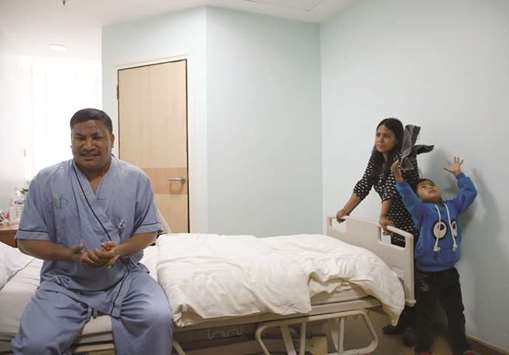 Daya Ram Tamrakar, a survivor from US-Bangla plane crash, speaks during an interview as his wife and son stand next to him, while undergoing treatment at a hospital in Kathmandu yesterday.