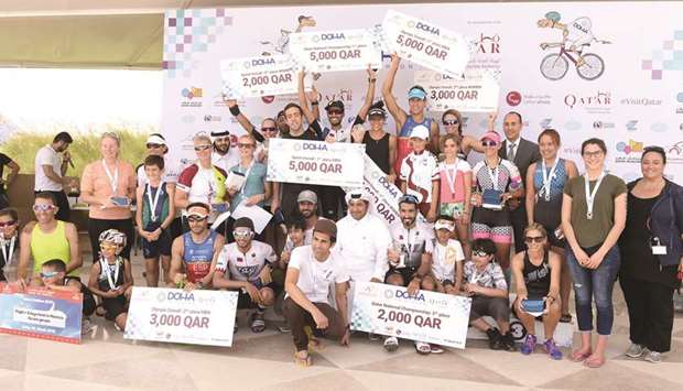 Winners of the Doha Triathlon 2018 pose with their medals.