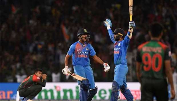 Dinesh Karthik (right) and Washington Sundar react after scoring the winning run to defeat Bangladesh by 4 wickets in Colombo on Sunday.