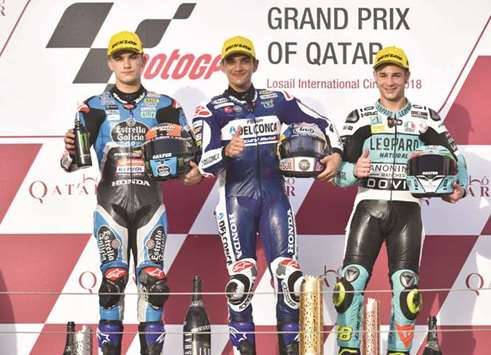 Moto3 winner Jorge Martin (c) celebrates his Moto3 victory on the podium with runner-up Aron Canet (L) and third-placed Lorenzo Dalla Porta. PICTURE: Noushad Thekkayil