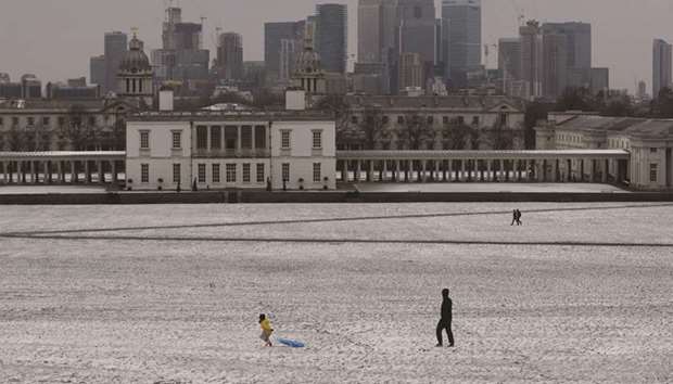 People walk through the snow in Greenwich Park, London, yesterday.