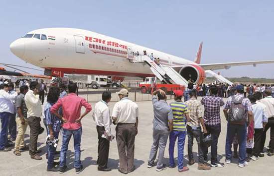 In this file photo taken on March 18, 2016, visitors line up to enter an Air India Boeing 777 on display during the India Aviation 2016 airshow at Begumpet airport in Hyderabad. India has witnessed a six-fold increase in passenger numbers over the past decade as citizens take advantage of better connectivity and cheaper fares thanks to a host of low-cost airlines.