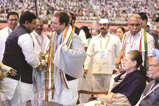 Congress delegates from Andhra Pradesh greet party president Rahul Gandhi during the 84th plenary session of the party as former prime minister Manmohan Singh and chairperson of the United Progressive Alliance Sonia Gandhi look on.