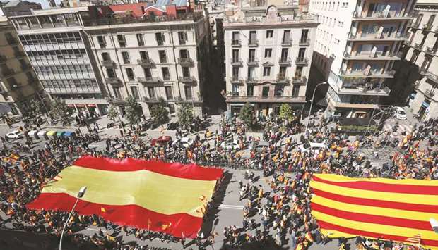 People hold Spanish flags during a demonstration called by u2018Sociedat Civil Catalanau2019 (Catalan Civil Society) to support the unity of Spain in Barcelona yesterday.