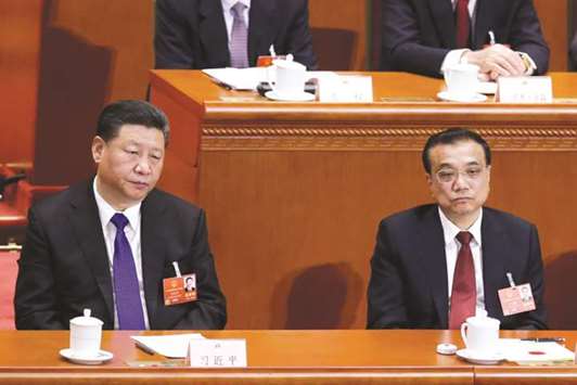 Chinese President Xi Jinping (left) and Chinese Premier Li Keqiang attend the sixth plenary session of the National Peopleu2019s Congress (NPC) at the Great Hall of the People in Beijing, China.