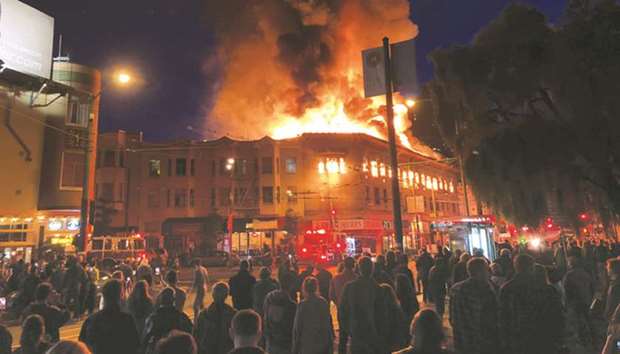 Fire burns up the top floor of a building in the North Beach neighbourhood of San Francisco late on Saturday. No injuries were reported.