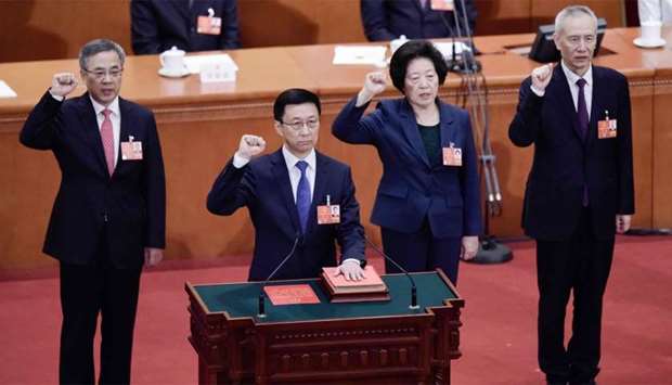 Newly elected Vice Premiers Hu Chunhua (L), Sun Chunlan (2nd R) and Liu He (R), led by Han Zheng (2nd L), take an oath