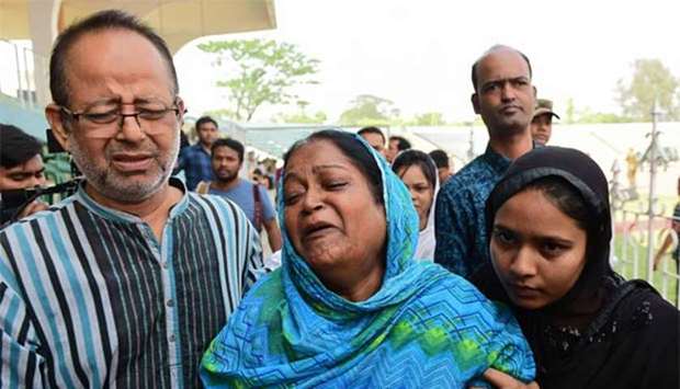 Bangladeshi relatives of victims of the US-Bangla plane crash in Kathmandu react as they receive the bodies in Dhaka on Monday.