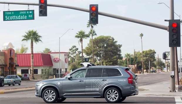A self-driving Volvo vehicle, purchased by Uber, moves through an intersection in Scottsdale, Arizona in this file picture.