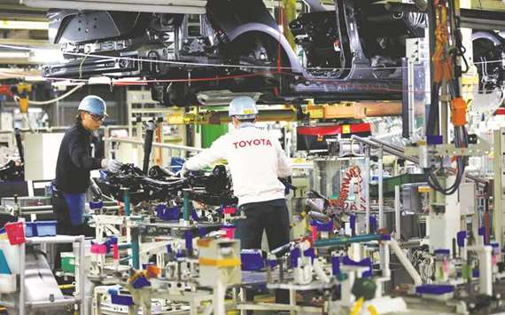 Employees work at an assembly line of the Toyota Motoru2019s Prius hybrid car at the Tsutsumi plant in central Japan. The countryu2019s automobile shipments to the US jumped 12.3% in February.