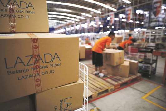 Employees at online retailer Lazada fill orders at the companyu2019s warehouse in Jakarta. One of the 18 founders of Alibaba, veteran executive Lucy Peng, will take over as Lazadau2019s chief executive, replacing founder Max Bittner who will become a senior adviser to Alibaba.