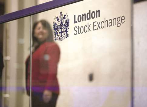 A visitor passes a sign inside the London Stock Exchange. The FTSE 100 closed down 1.7% at 7,042.93 points yesterday.