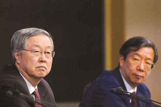 Yi Gang, deputy governor of the Peopleu2019s Bank of China (right), and Zhou Xiaochuan, governor of PBoC, attend a news conference on the sidelines of Chinau2019s National Peopleu2019s Congress in Beijing. Yi is seen as instrumental in steering monetary and currency policy, including the landmark devaluation of the yuan in 2015 and more recently a tightening in capital controls.