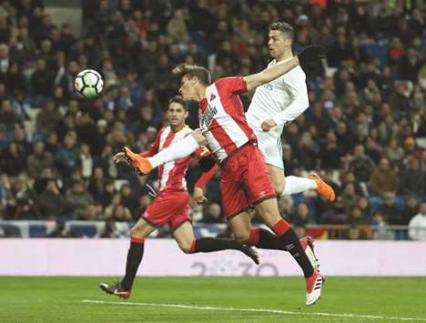 Gironau2019s Bernardo Espinosa (left) vies for the ball with Real Madridu2019s Cristiano Ronaldo in Madrid on Sunday night. (Reuters)