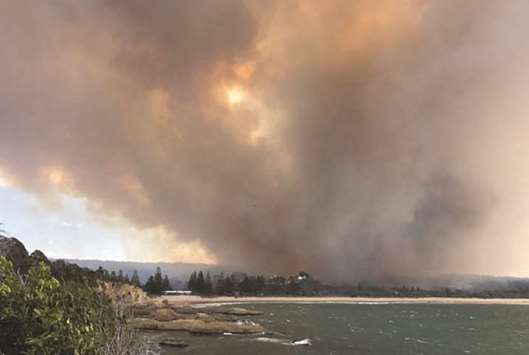 This handout photo taken on Sunday and received yesterday from David Porter shows smoke rising from fires in the village of Tathra on the south coast of New South Wales.