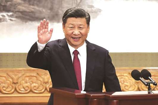 This file photo taken on October 25, 2017 shows Chinese President Xi Jinping waving at the Great Hall of the People in Beijing. Chinau2019s Communist Party is calling for the removal of presidential term limits, Chinau2019s official news agency reported on February 25, 2018, paving the way for Xi Jinping to remain as head of state after 2023.
