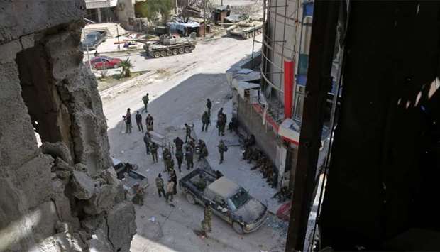 Syrian  forces gather at the main square of Kfar Batna, southeastern Ghouta