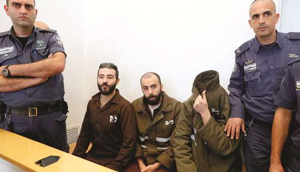 French national Romain Franck (right), 24, a worker at the French consulate, and Moufak al-Ajluni (left) and Mohamed Katout (centre) appear in court in the southern Israeli city of Beer Sheva, to face charges of smuggling guns from Gaza.