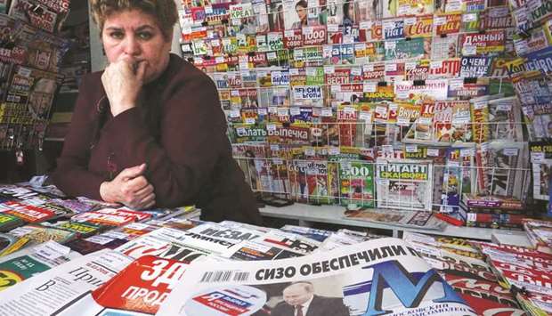 A newspaper with the front page featuring Putin after his re-election is seen at a newstand in Moscow.