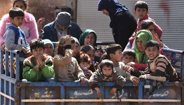 Civilians, fleeing the city of Afrin in northern Syria, are seen arriving in the village of az-Ziyarah, in the government-controlled part of the northern Aleppo province, yesterday.
