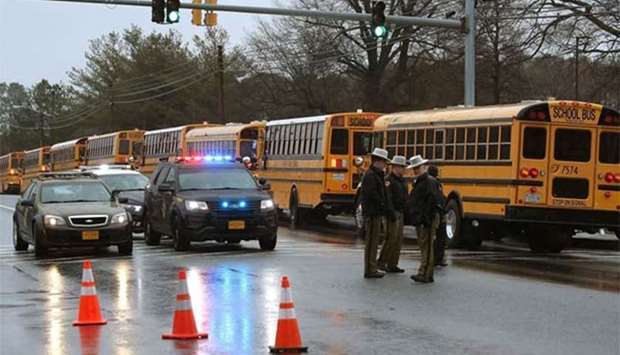 School buses are lined up in front of Great Mills High School after a shooting in Great Mills, Maryland on Tuesday.