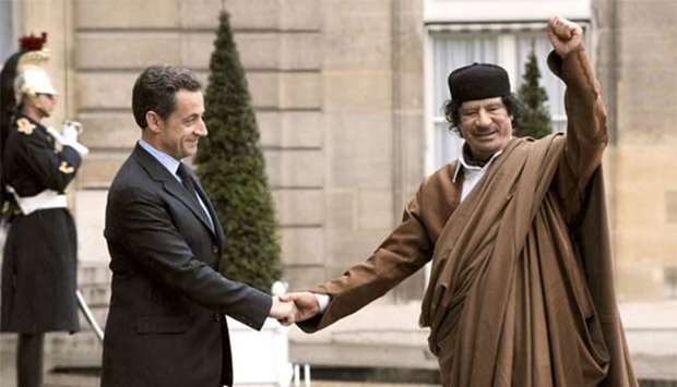 Muammar Gaddafi is seen with Nicolas Sarkozy in this December 2007 file picture.