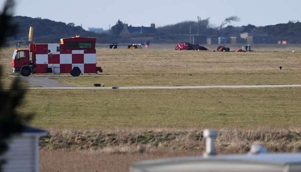 Debris from a crashed Royal Air Force (RAF) jet lays on the grass close to the runway at RAF Valley, at Anglesey Airport in Anglesey, north Wales.