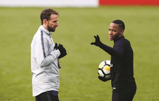 England manager Gareth Southgate (left) talks to Raheem Sterling during a training  session at Georgeu2019s Park, Burton Upon Trent, Britain, yesterday. (Reuters)