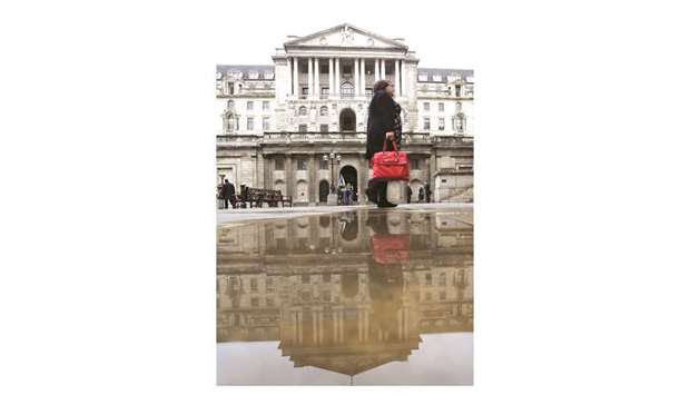A pedestrian walks past the Bank of England in London. The BoEu2019s decision is taking place amid a flurry of UK economic data this week, including labour market and retail sales reports.