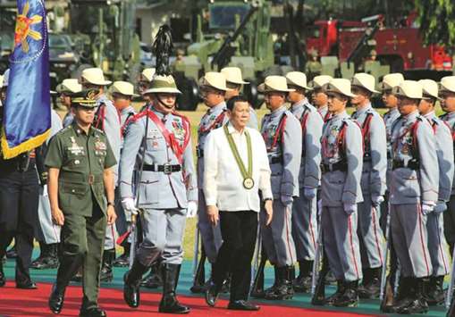 Philippine President Rodrigo Duterte reviews honour guards upon his arrival during the 121st founding anniversary of the Philippine Army (PA) in Taguig city, Metro Manila, Philippines.