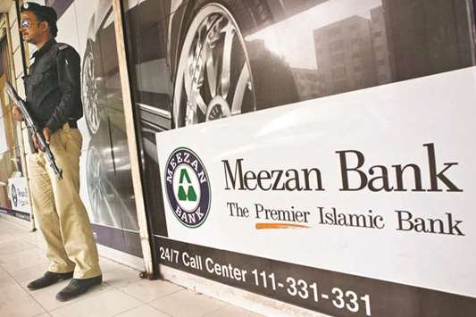 A security guard is on guard outside a Meezan Bank branch in Karachi (file). Deputy governor Jameel Ahmad at the State Bank of Pakistan said the Islamic finance industry needs to expand its product menu with special focus to reach out to the unserved/underserved sectors and regions of the economy.