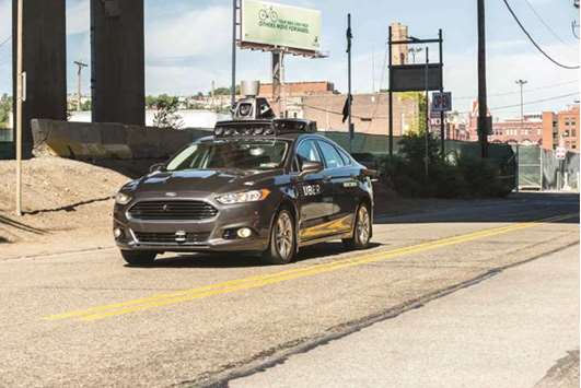 In this file photo taken on September 13, 2016, a pilot model of an Uber self-driving car travels in Pittsburgh, Pennsylvania.