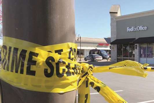 A police crime scene tape blocks off the FedEx store at Schertz, Texas.