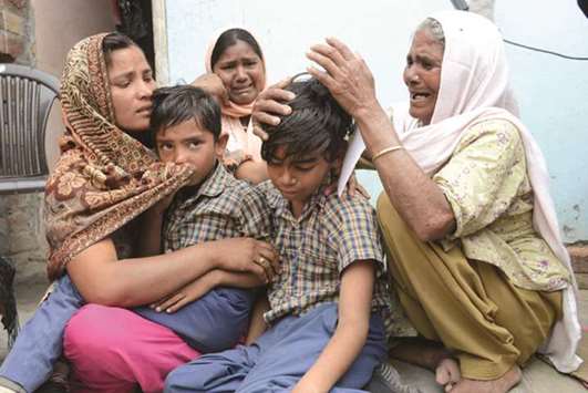 Seema (left), her sons and her mother in-law Jeeto, mourn the death of her husband Sonu in the village of Chawinda Devi some 22kms from Amritsar, yesterday.